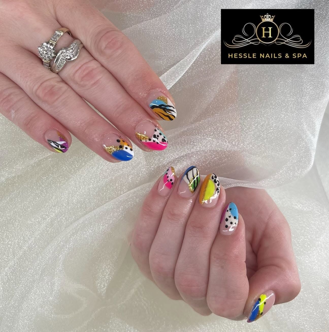 Colourful abstract nail art with animal print and gold glitter
